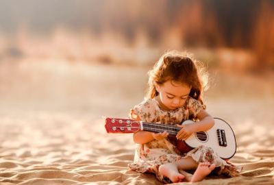Cute Little Girl Playing Guitar