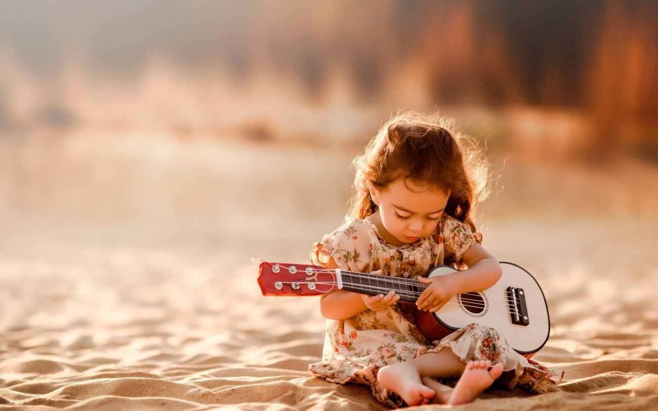 Cute Little Girl Playing Guitar