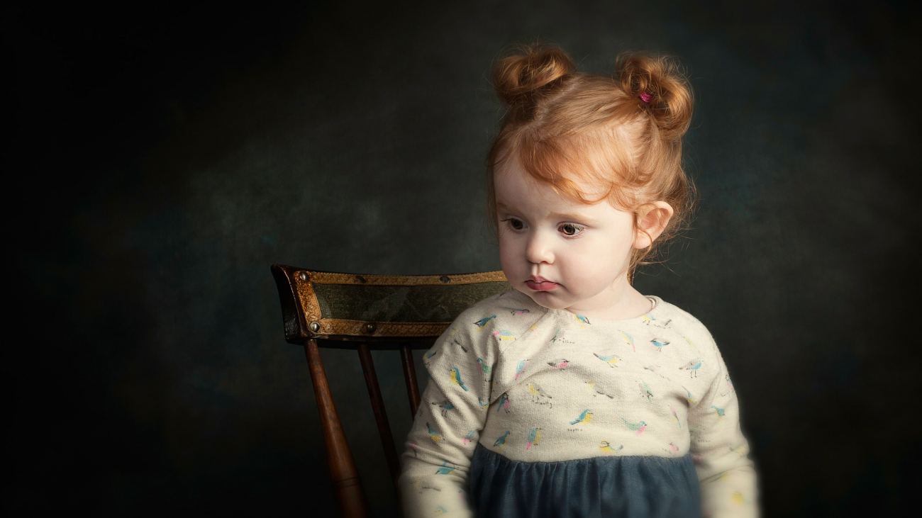 Cute Little Girl Sitting on Chair