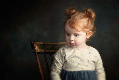 Cute Little Girl Sitting on Chair