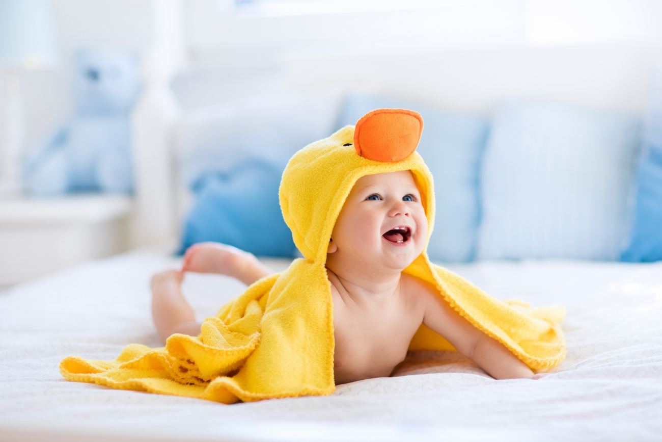 Smiling Cute Baby on Bed 4K Wallpaper